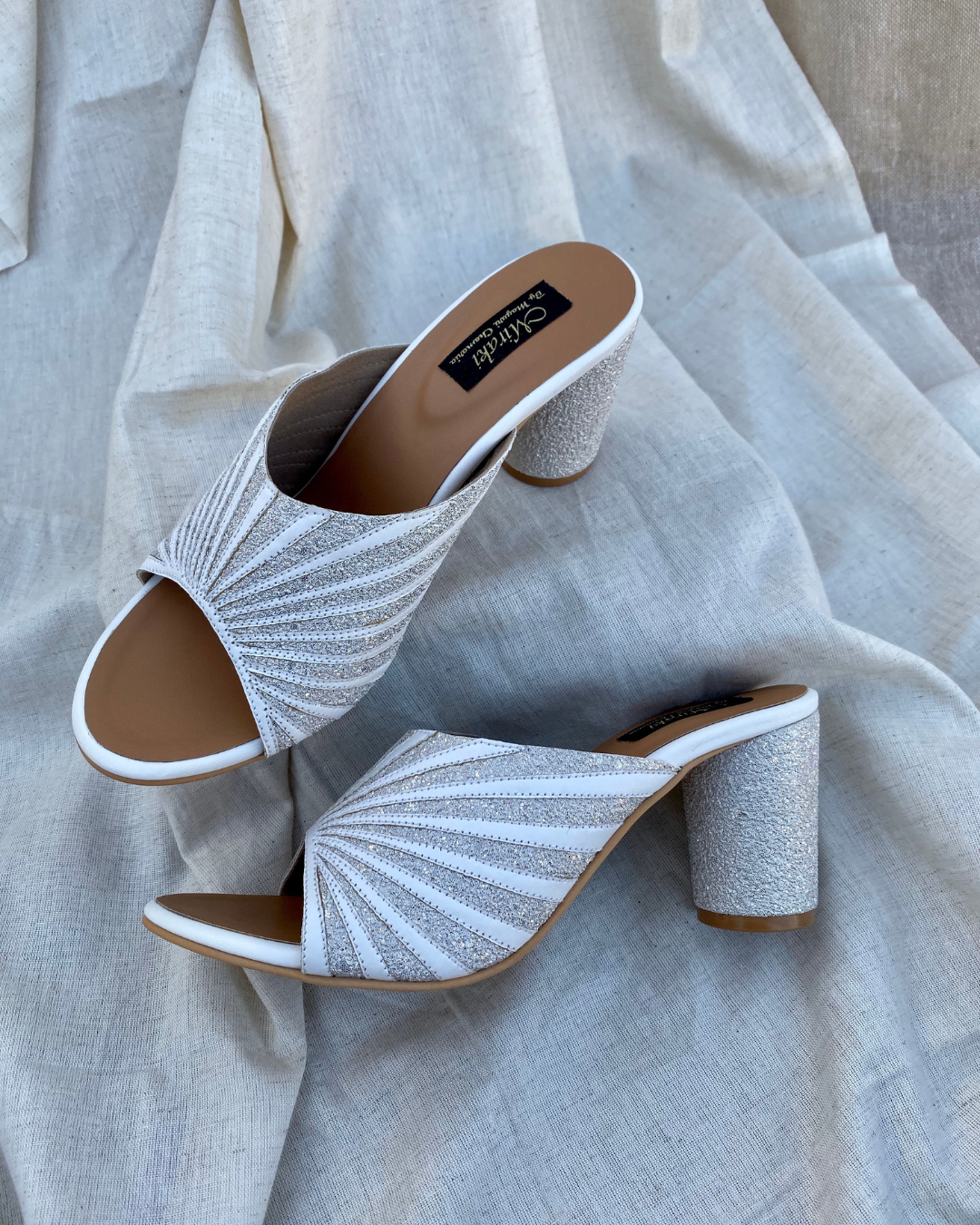 White Pattern Cut Slip Ons With Rounded Heels