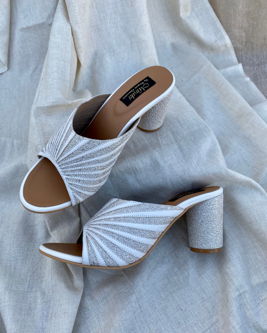 White Pattern Cut Slip Ons With Rounded Heels
